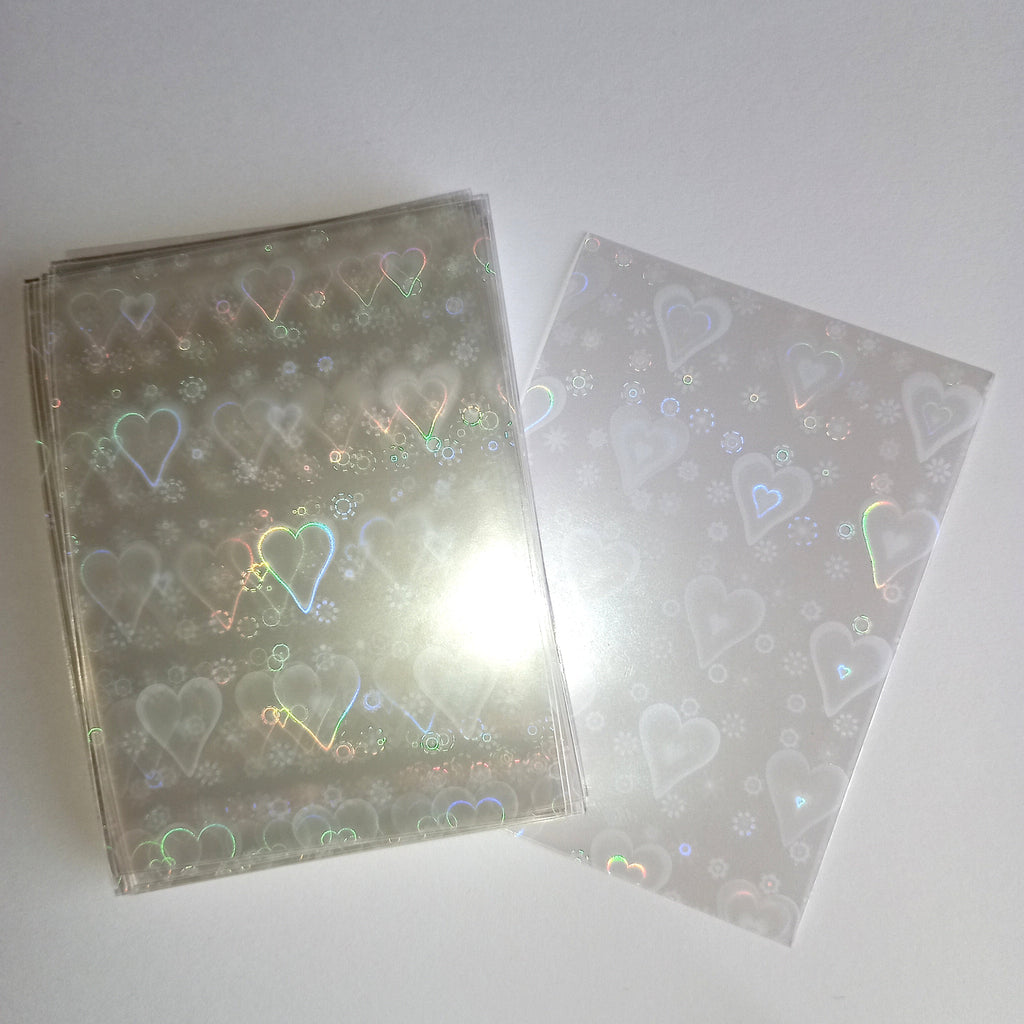 50 vnt. holografinės kortelių įmautės (sleeves) 65×90 mm – Pokémon, MTG, TCG kortelėms Hearts